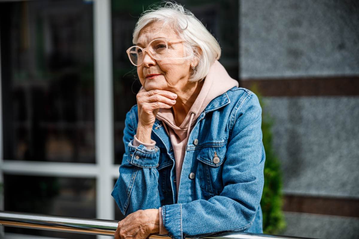 femme âgée en situation d'isolement à l'extérieur avec le regard dans le vide